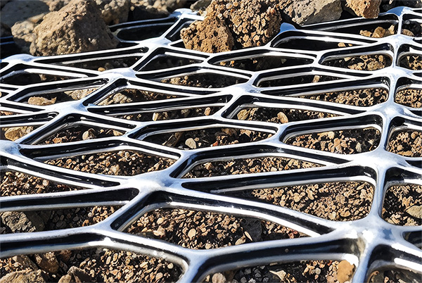 A close up shot of Tensar geogrid sitting atop aggregate at a construction site.