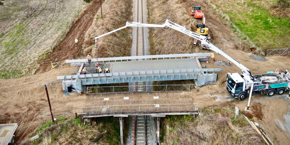 InQuick bridge system being finalized, stretching over a railroad track.